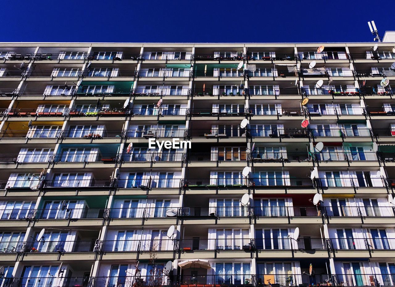 Low angle view of building windows against clear sky