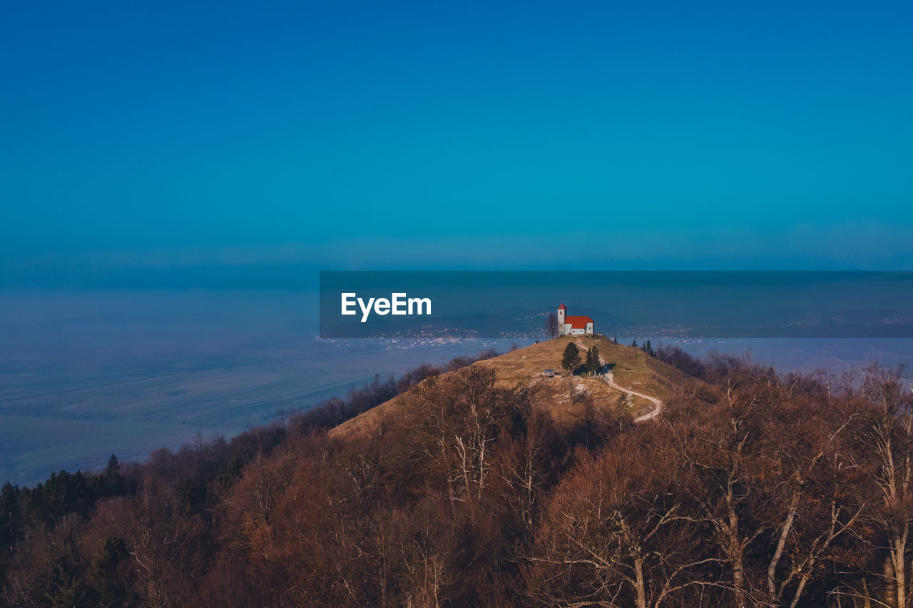 View of house on hill against landscape