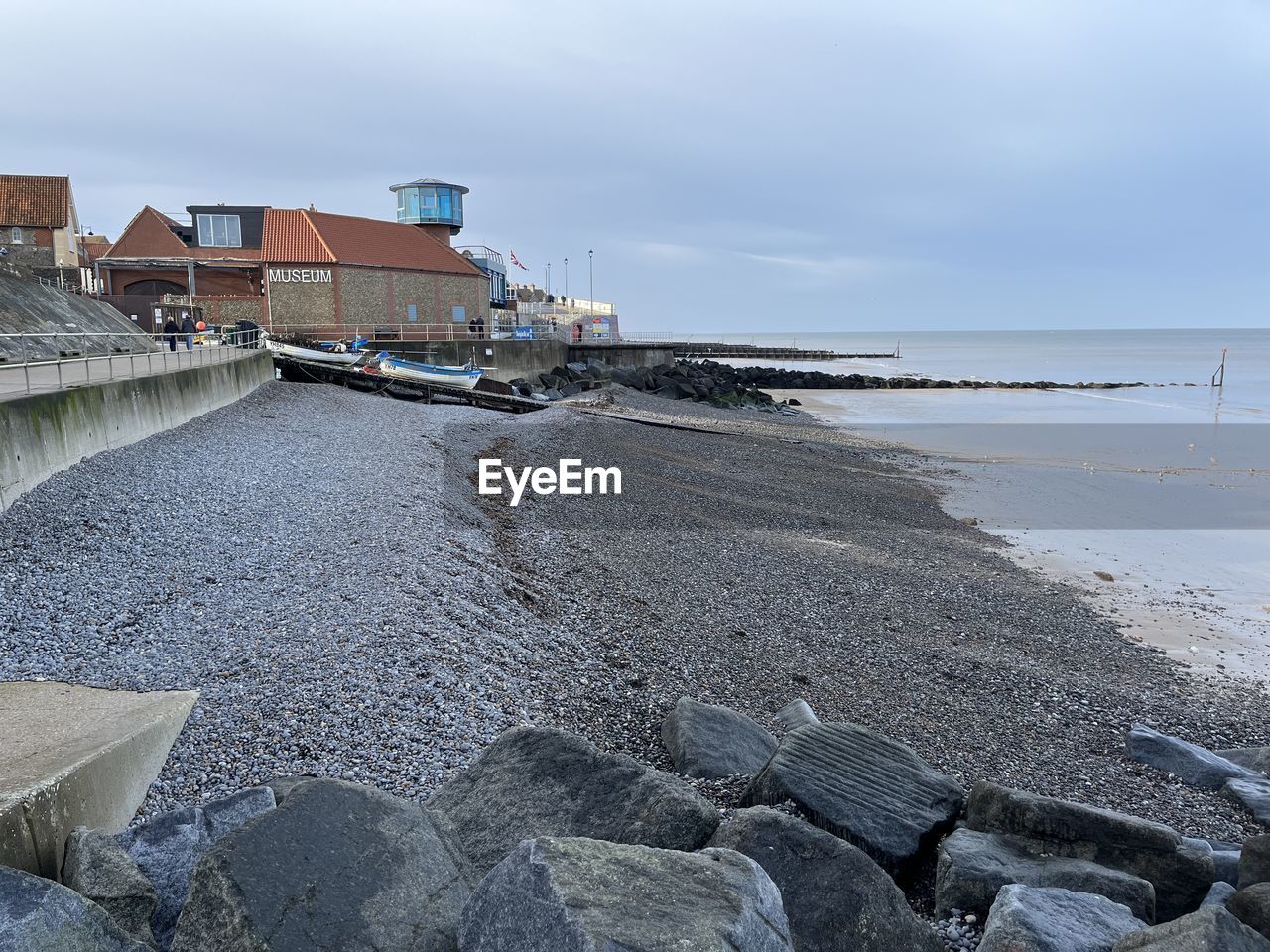 water, shore, coast, sea, sky, beach, land, architecture, ocean, nature, built structure, breakwater, cloud, building exterior, body of water, rock, no people, day, scenics - nature, beauty in nature, outdoors, building, wave, coastline, tranquility, environment, travel destinations, winter