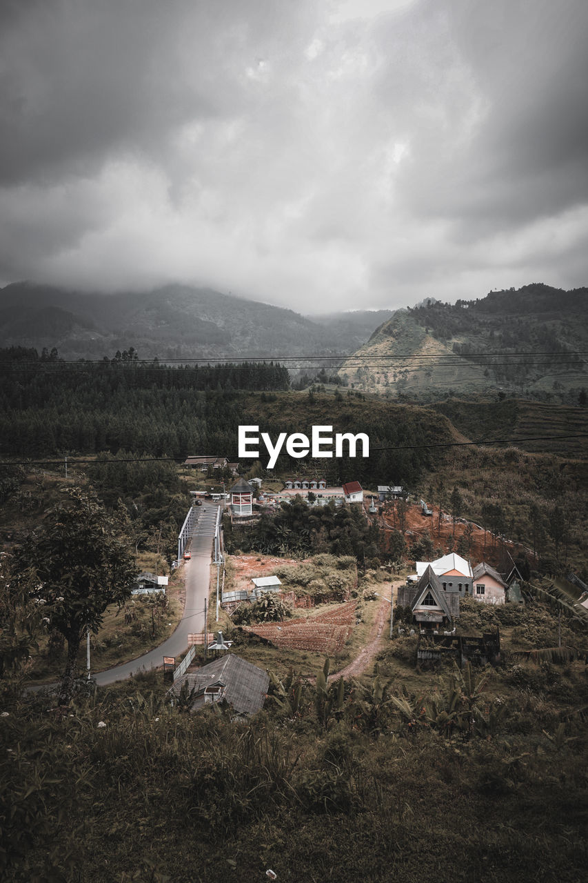Aerial view of landscape and buildings against sky
