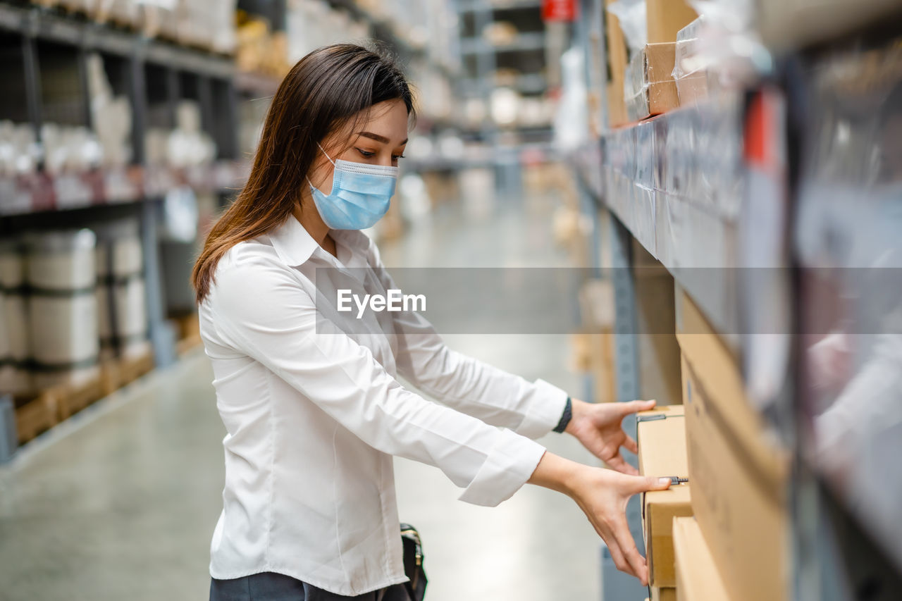 Midsection of woman standing at store