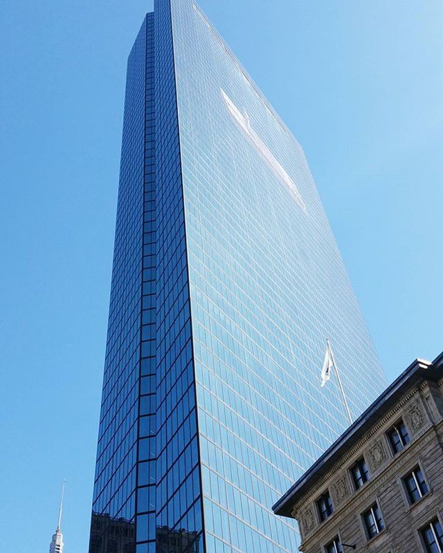 LOW ANGLE VIEW OF MODERN BUILDINGS AGAINST BLUE SKY