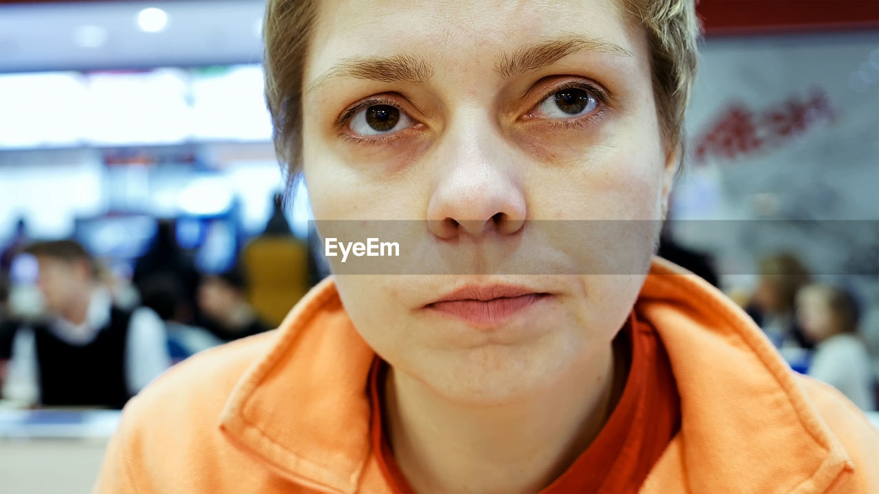 Close-up of woman looking away at restaurant