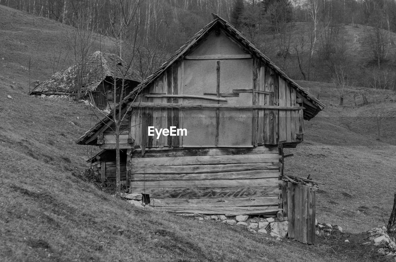 Abandoned log cabin on hill