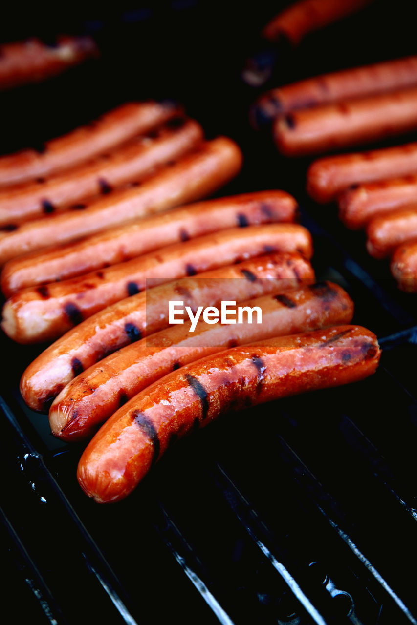 High angle view of sausages grilling on barbecue