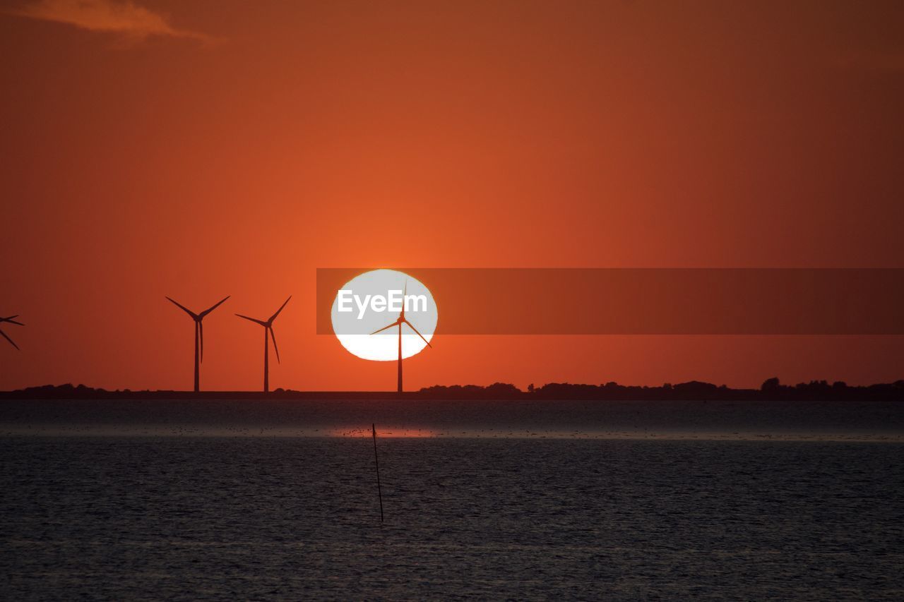 SCENIC VIEW OF SEA AGAINST ORANGE SKY