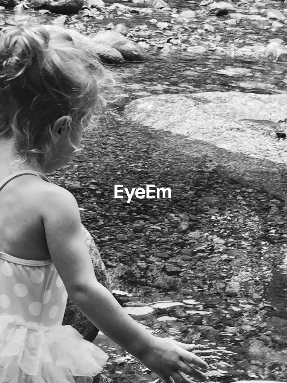 Rear view of girl standing at beach