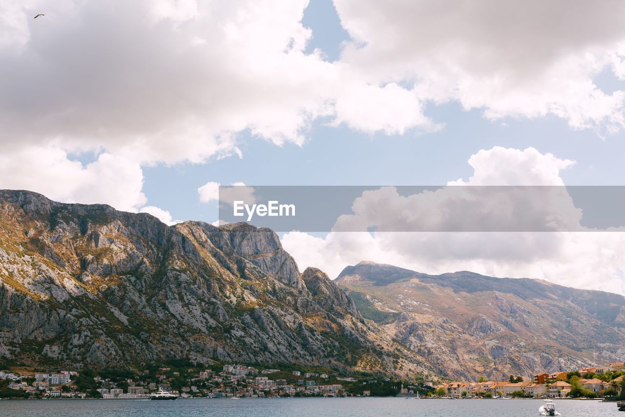 Scenic view of sea and mountains against sky