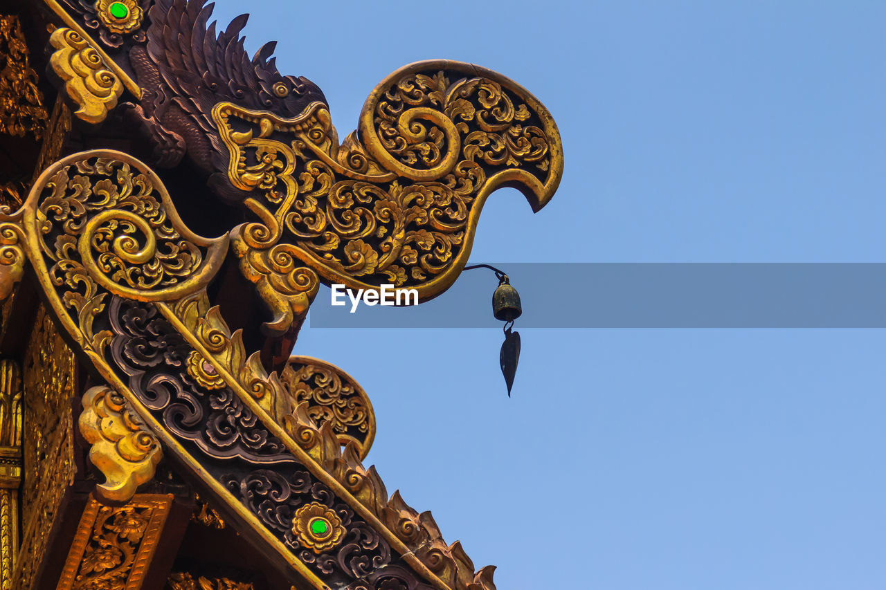 LOW ANGLE VIEW OF TEMPLE AGAINST BUILDING AGAINST CLEAR SKY