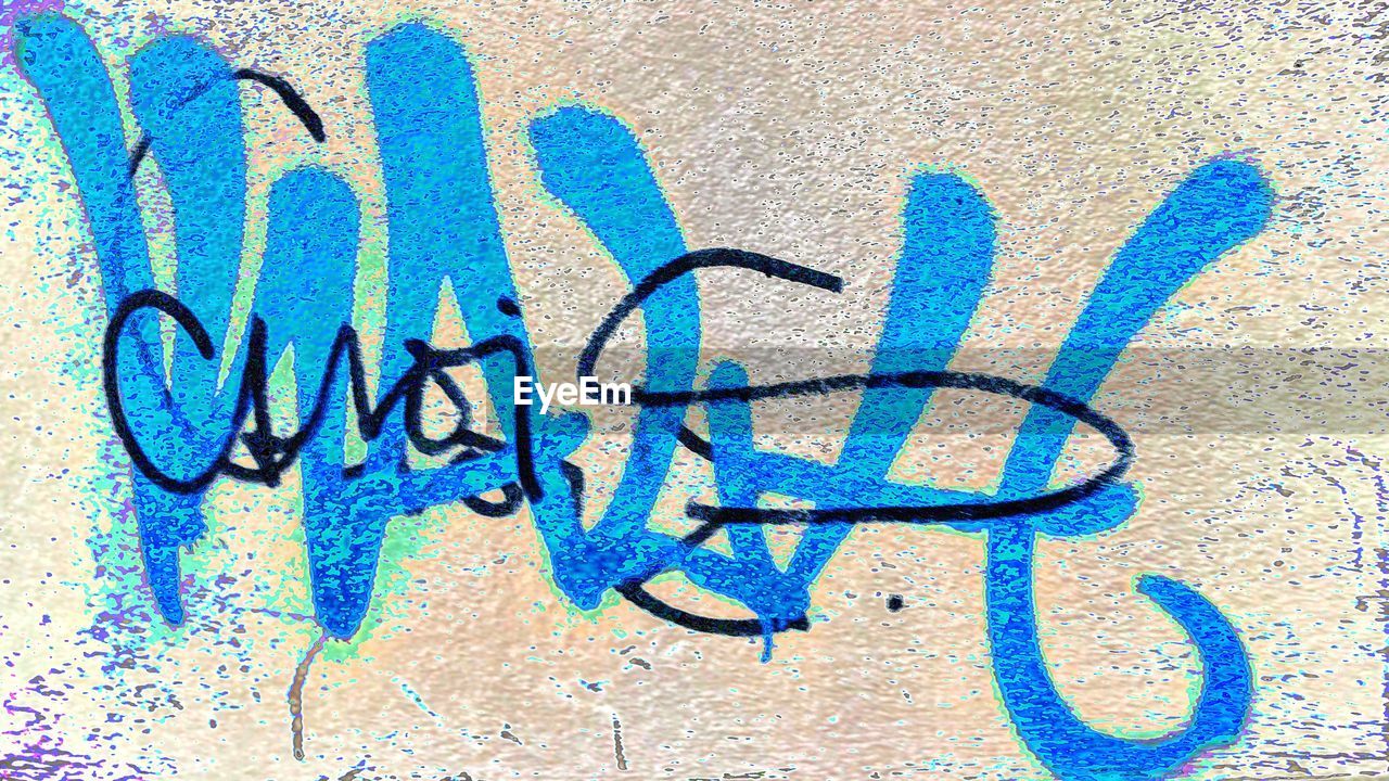 GRAFFITI ON BLUE WALL