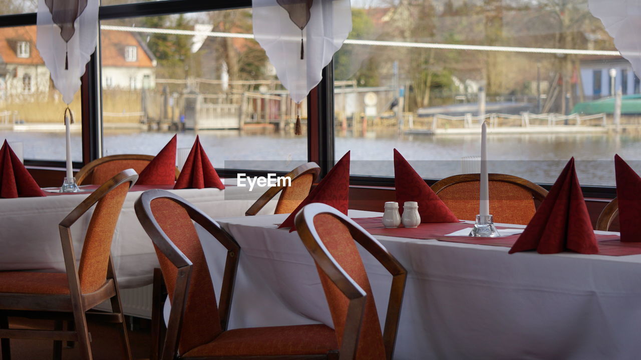 Close-up of chairs on table