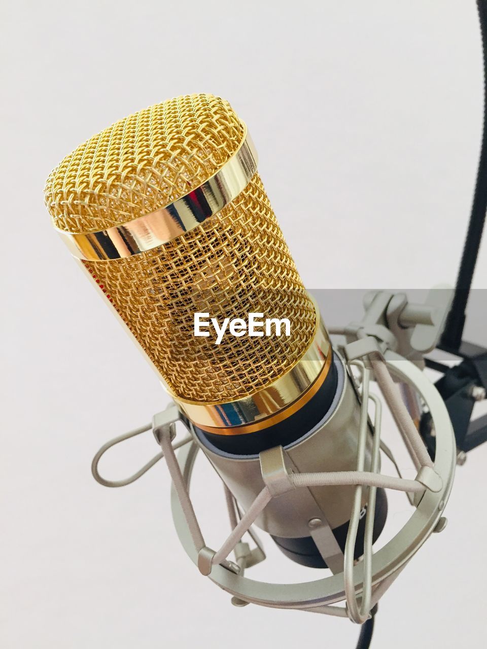 Close-up of microphone against white background