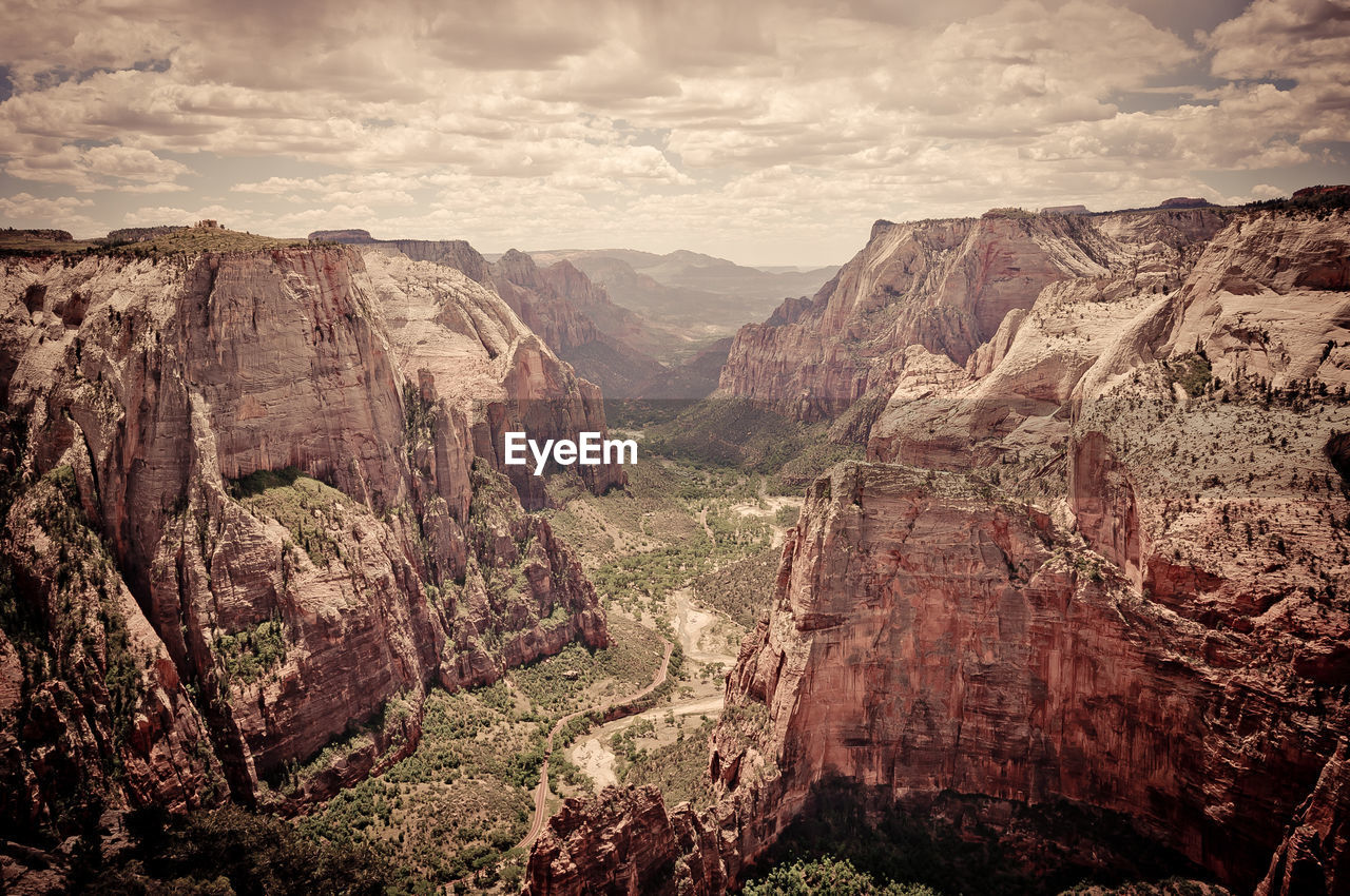 High angle shot of rocky landscape against clouds