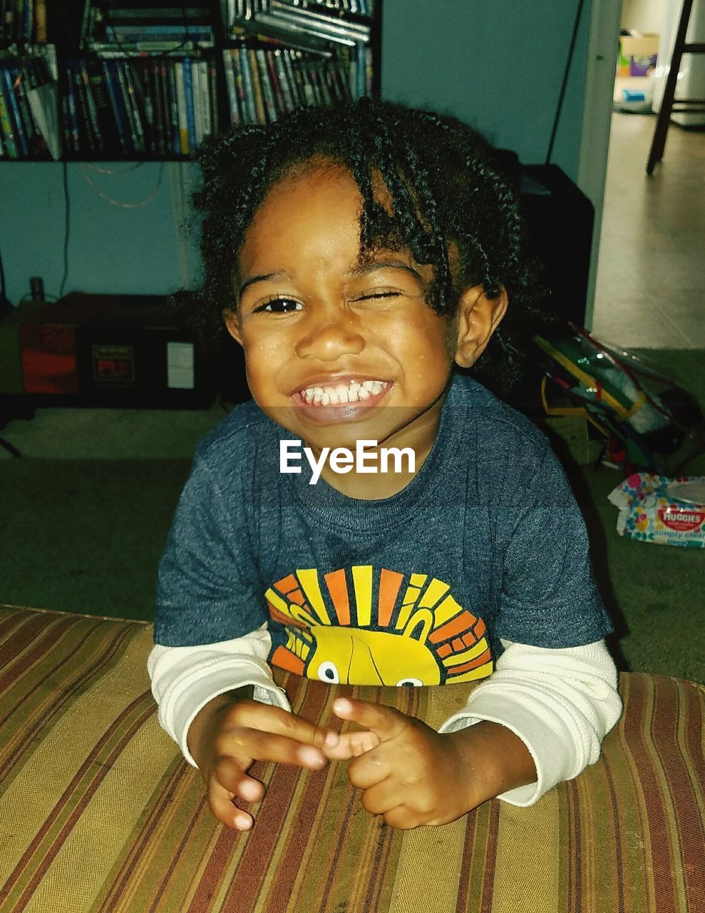 Portrait of boy blinking at home