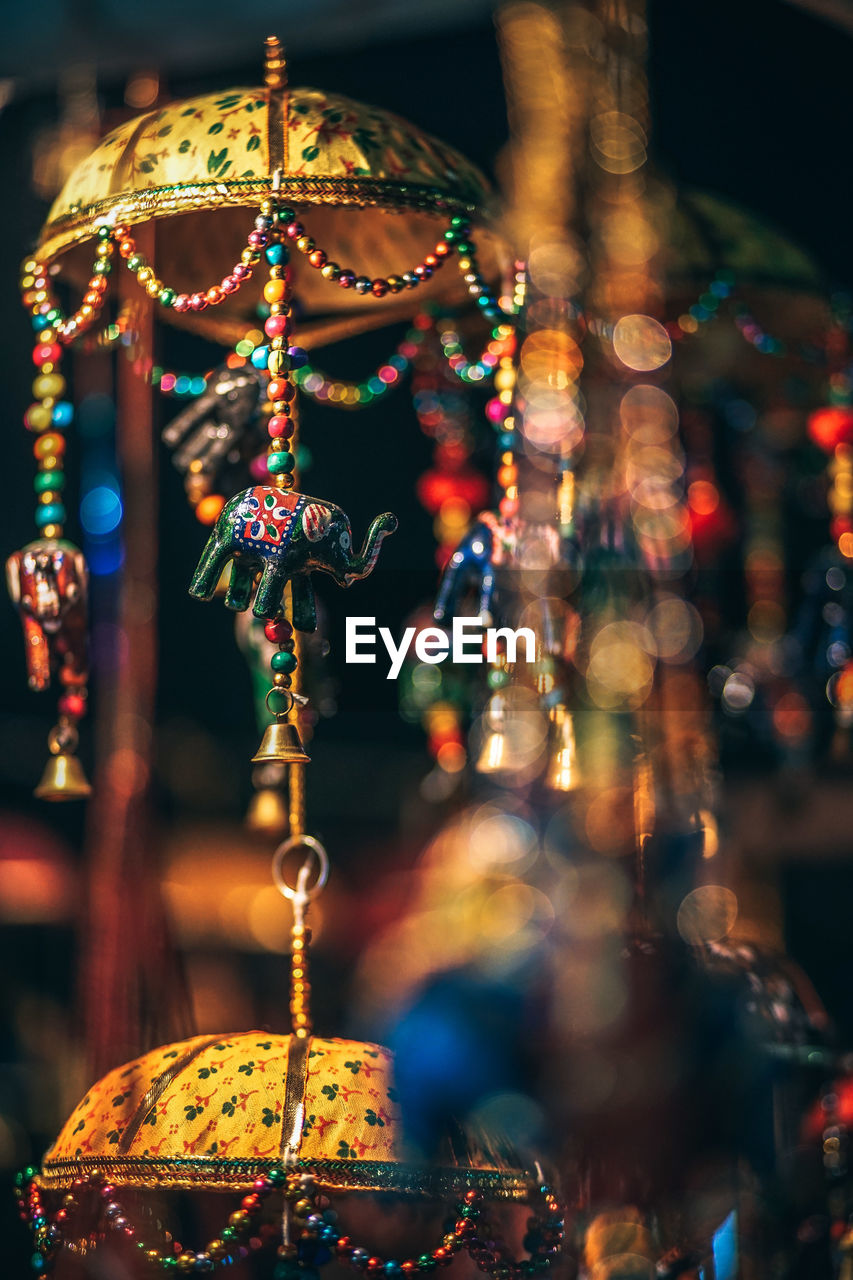 Close-up of decorations hanging for sale at market stall