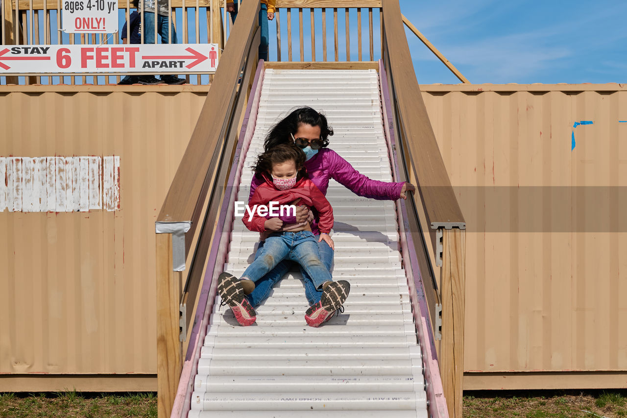 Mom and daughter going down the sllide at the county fair