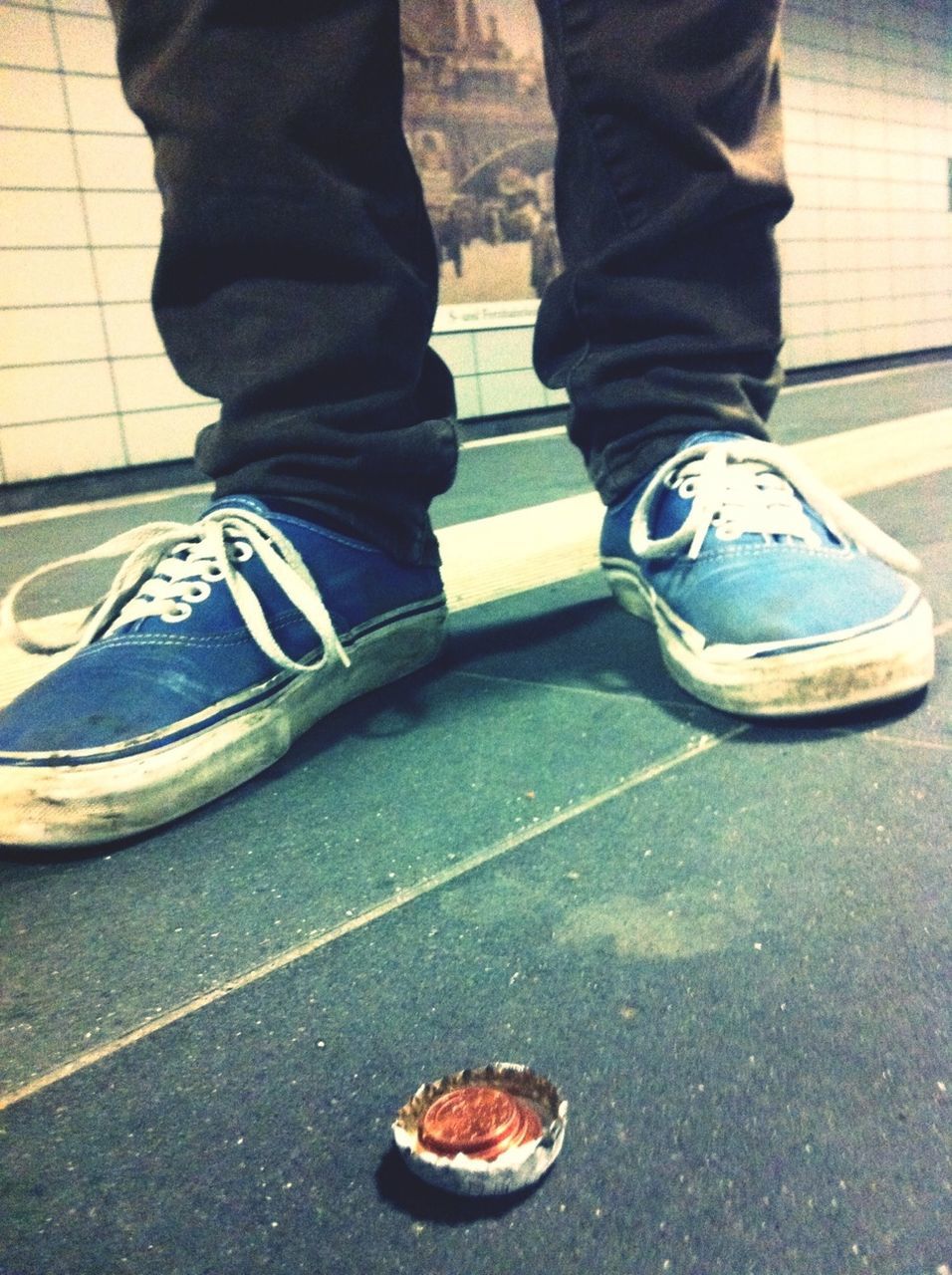 Low section of man standing on subway