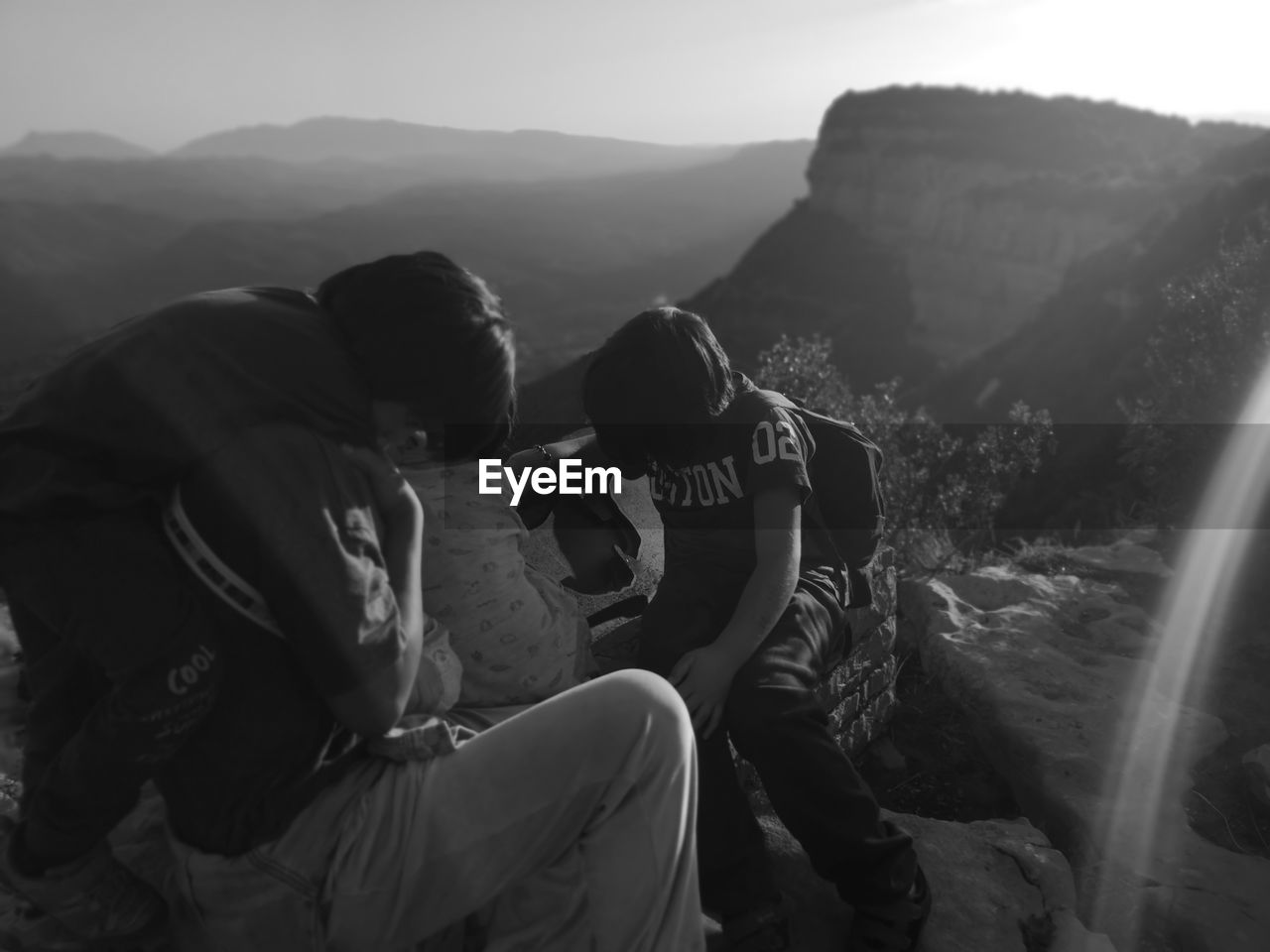 PEOPLE SITTING ON MOUNTAINS