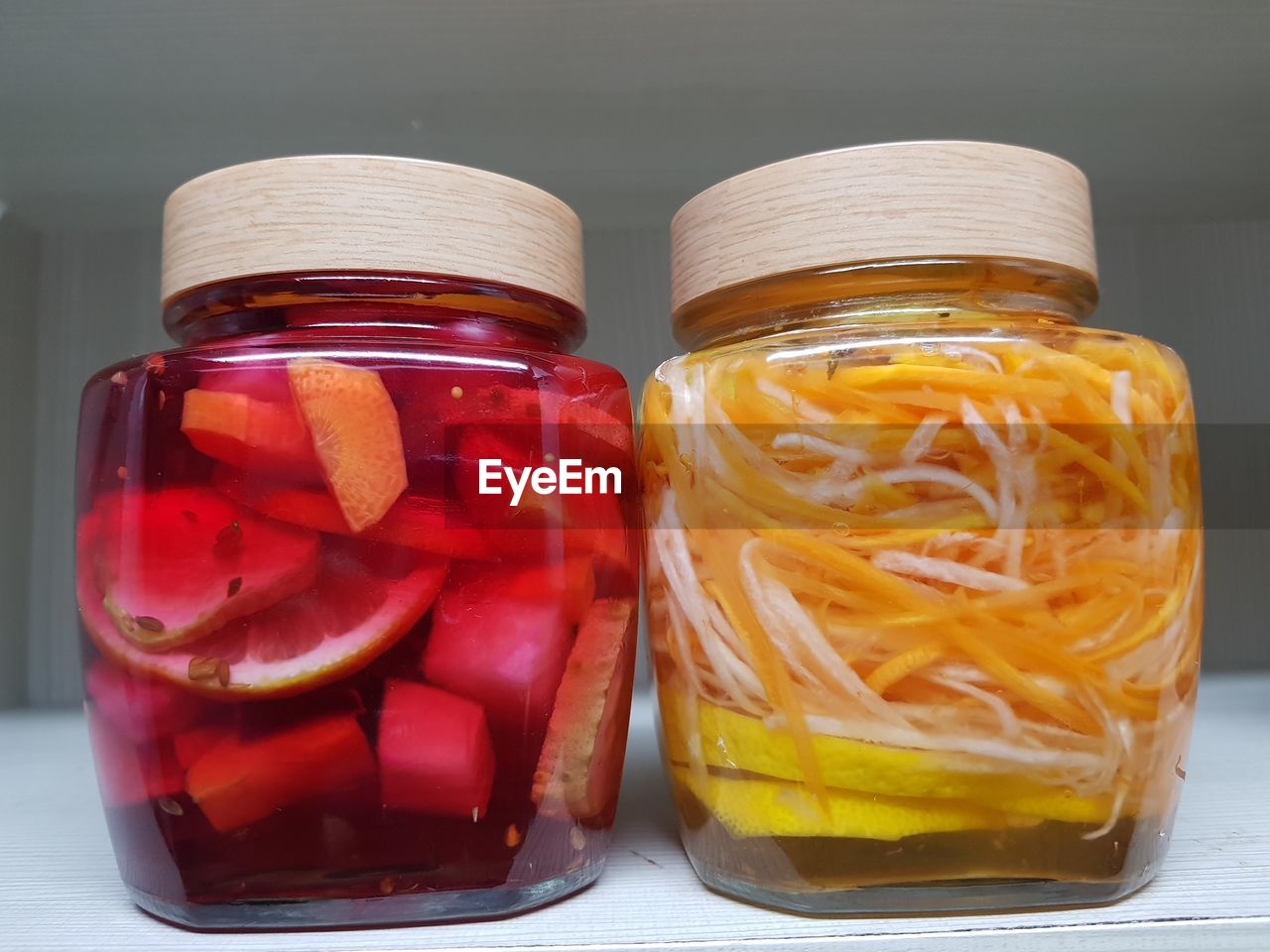 Fruits in jars on table