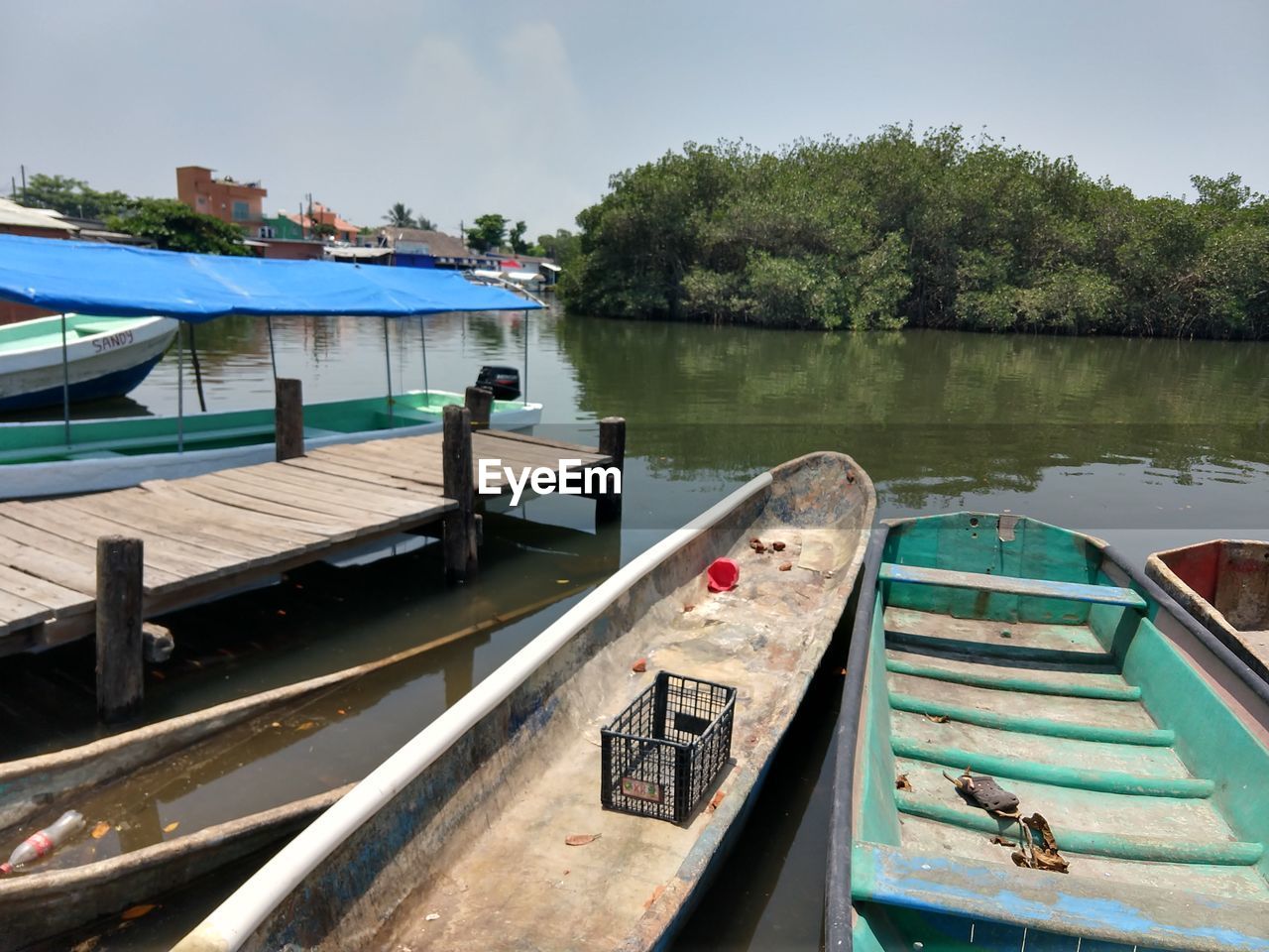 BOATS MOORED BY LAKE AGAINST SKY