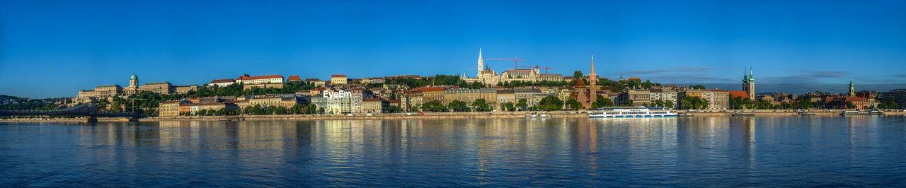 Panoramic view of the danube river and the embankment of buda on a sunny summer morning