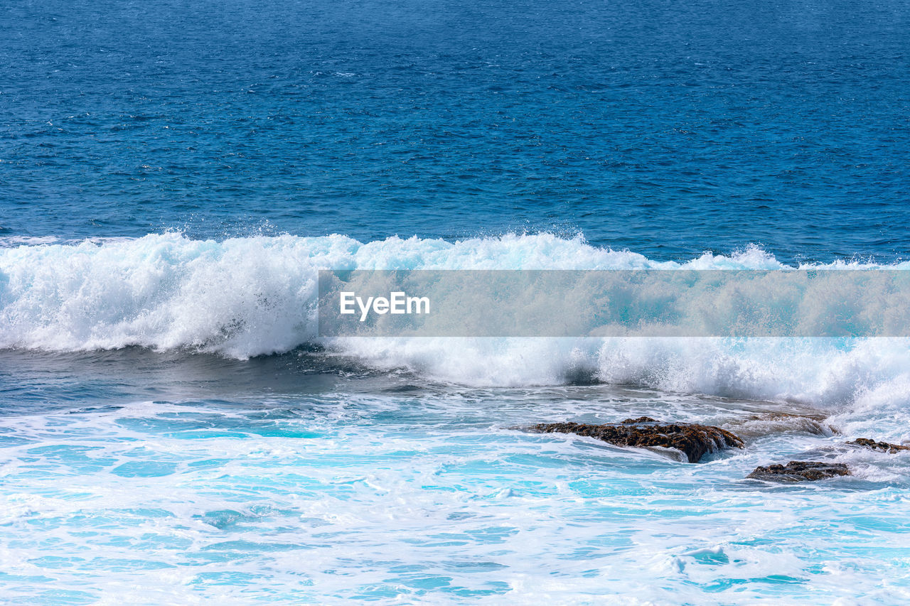 water, sea, wind wave, ocean, motion, beauty in nature, wave, shore, blue, nature, scenics - nature, sports, coast, no people, day, outdoors, water sports, land, splashing, beach, power in nature