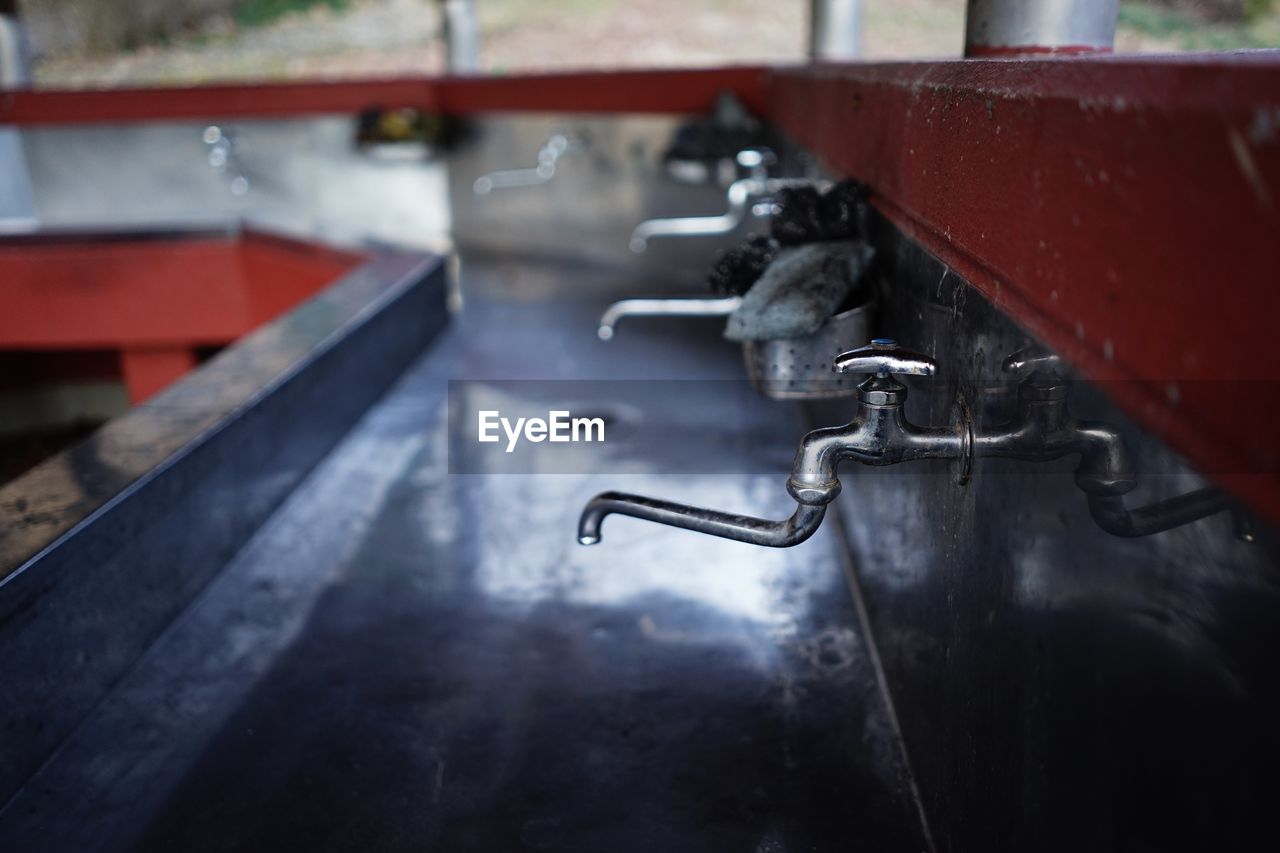 Close-up of faucet against white wall