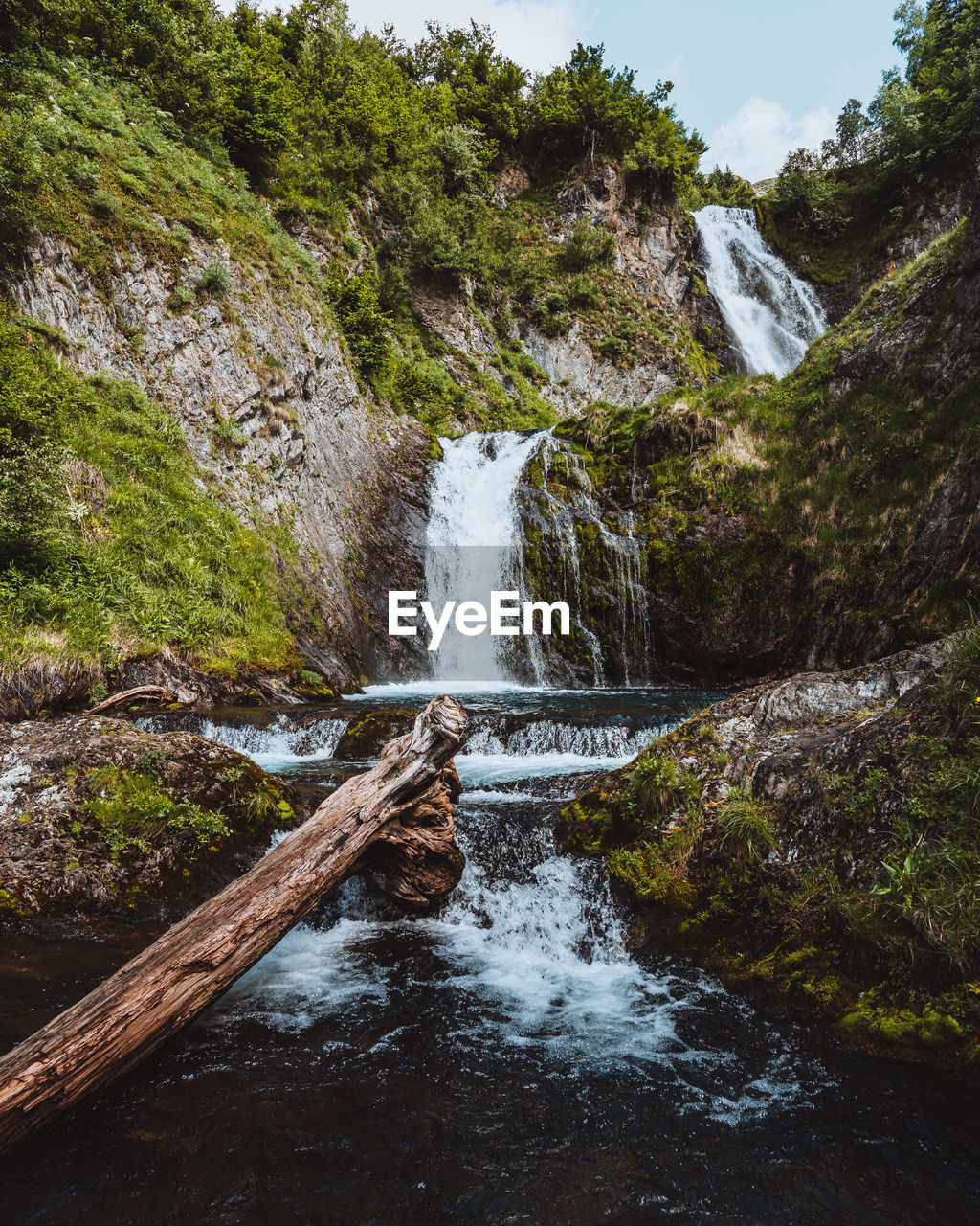 Scenic view of waterfall amidst rocks