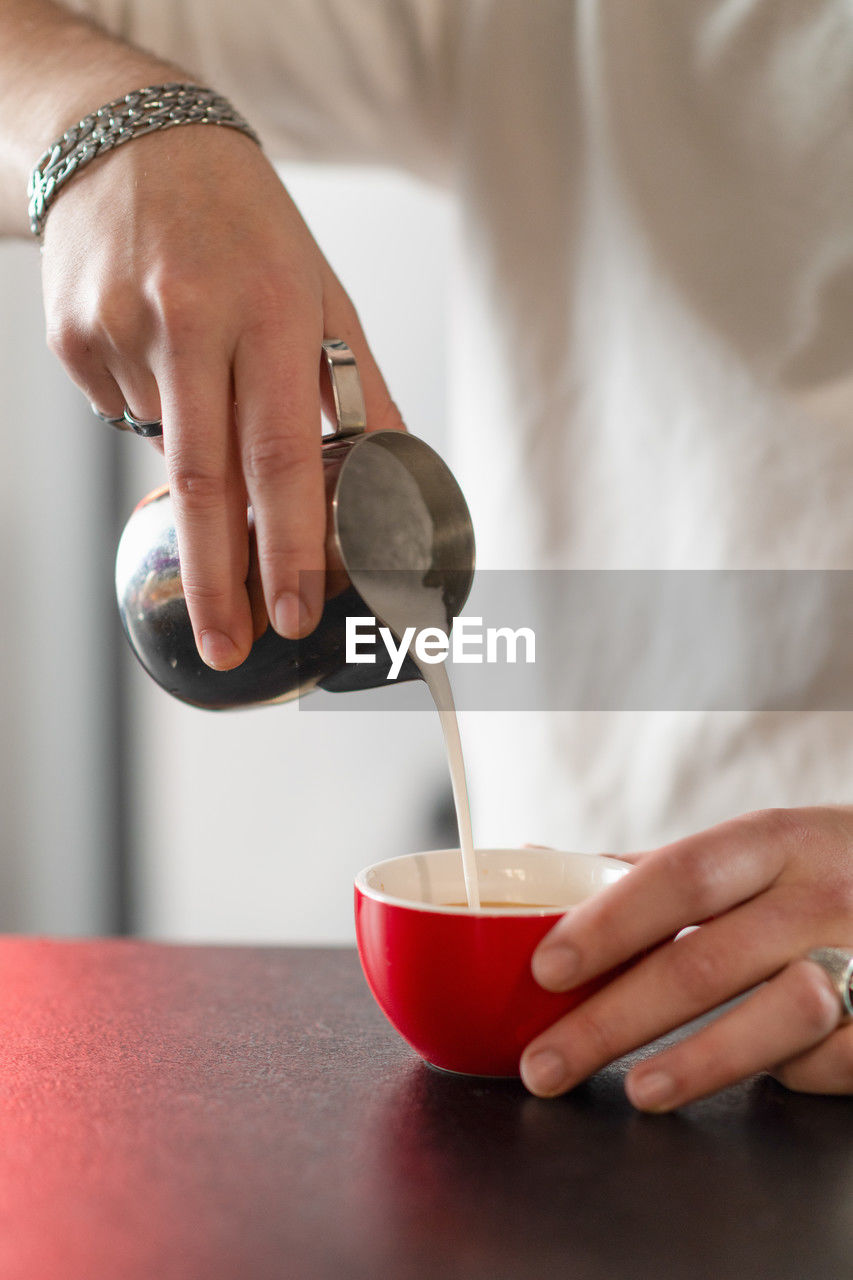 midsection of man preparing food in bowl