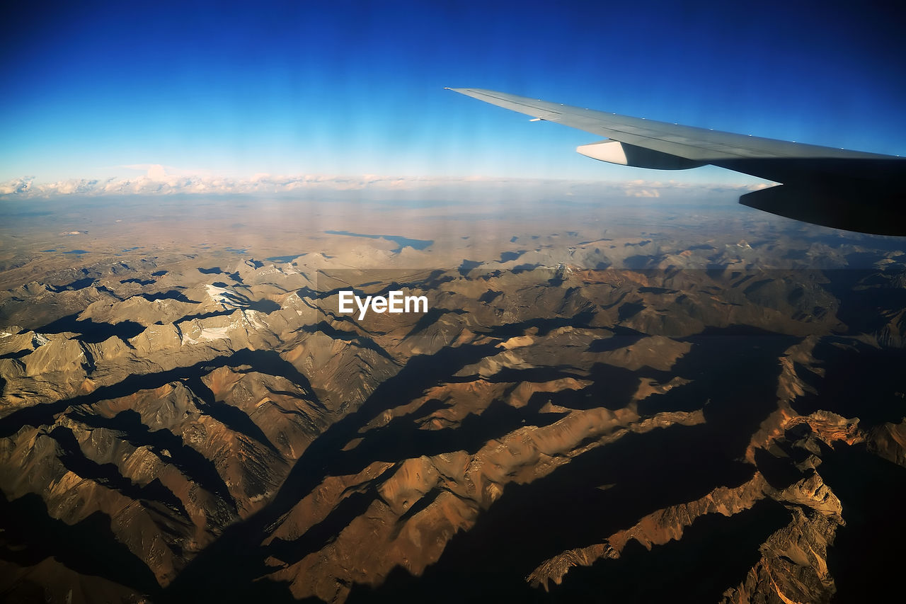 View of mountain range and aircraft wing