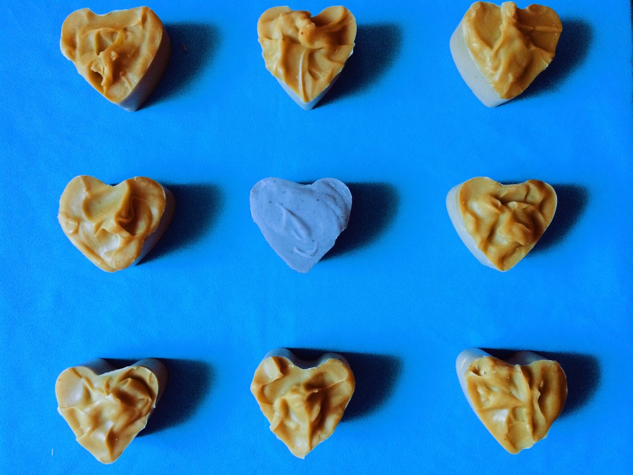 Directly above shot of heart shape soaps on blue background