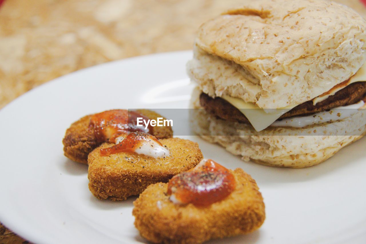 High angle view of bread and nugget in plate on table