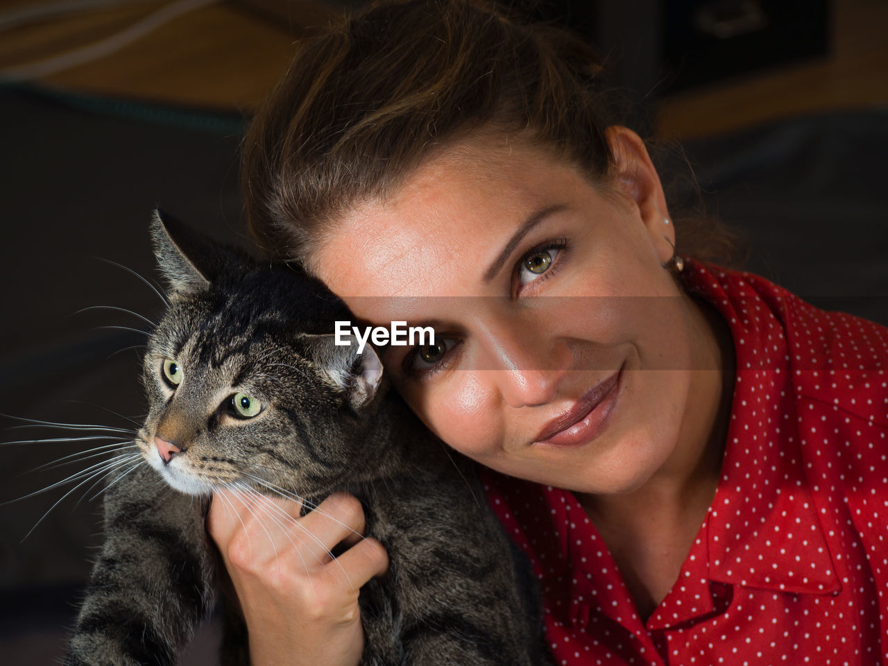 Portrait of smiling young woman with cat