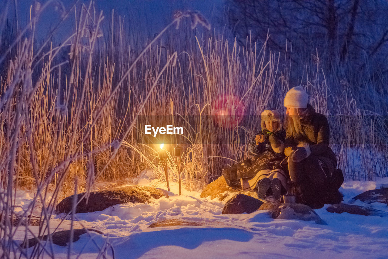 Mother and child in snow at night