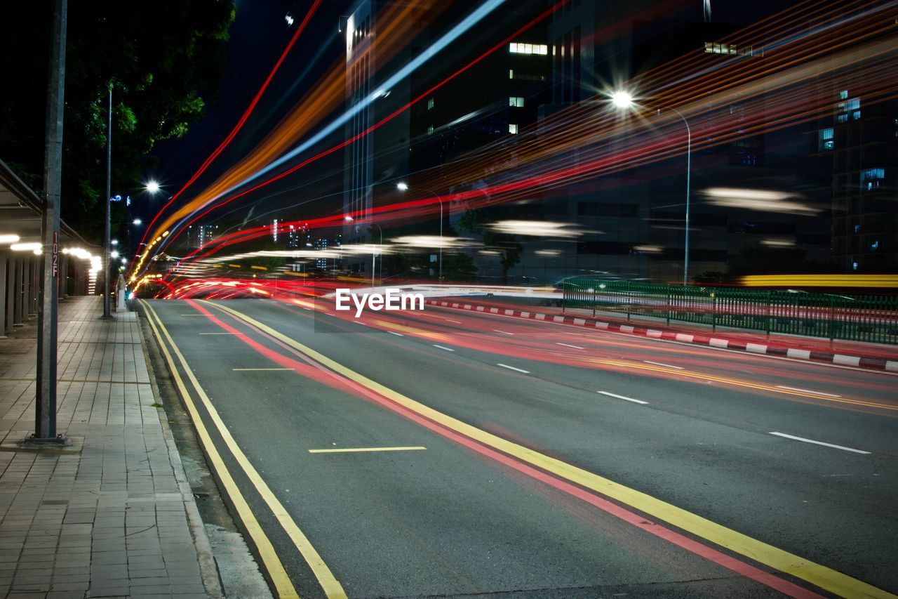LIGHT TRAILS ON ROAD IN CITY