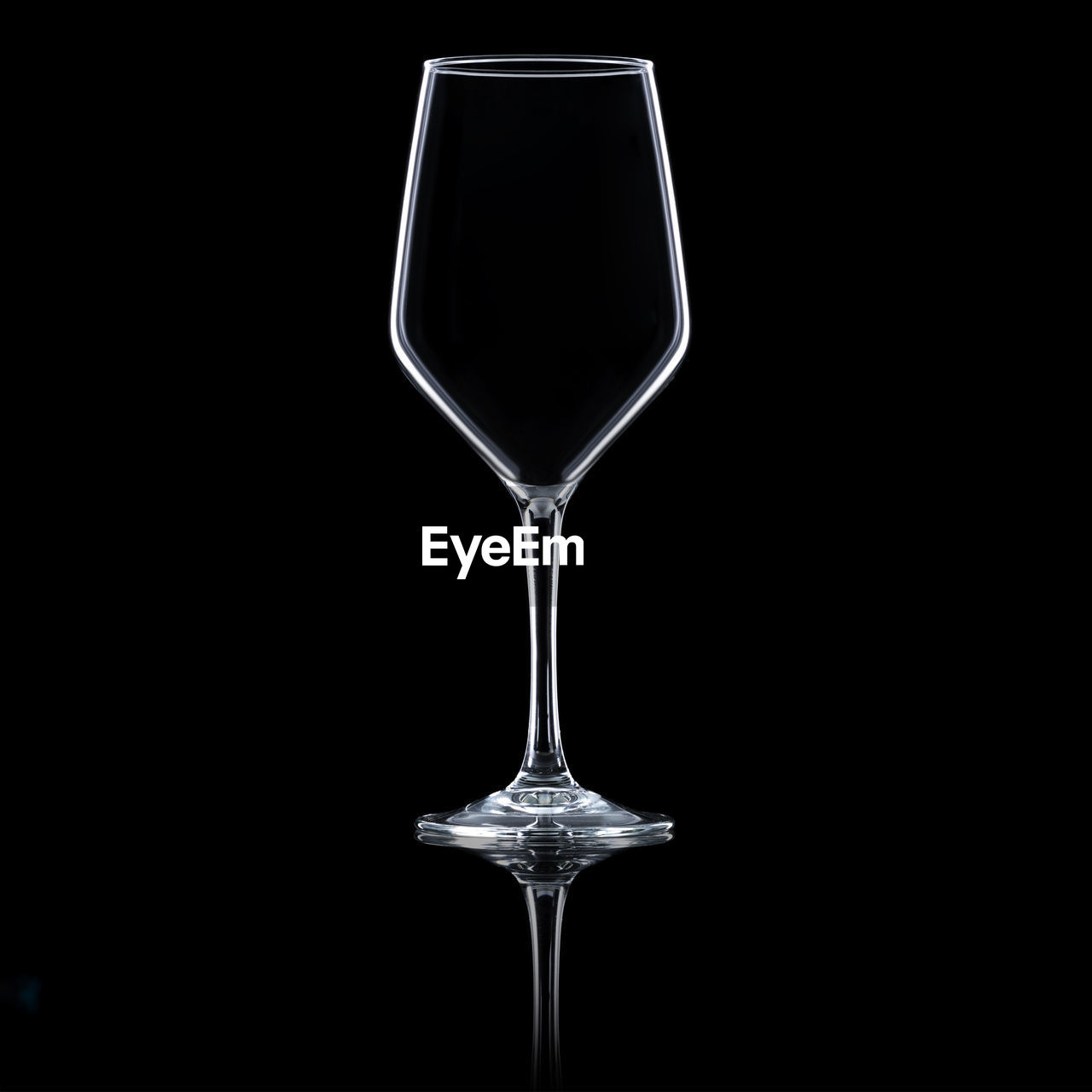 Empty wine glass on black background