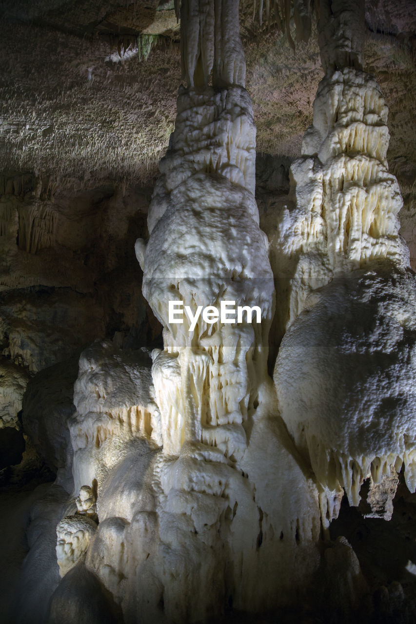 LOW ANGLE VIEW OF ROCK FORMATIONS AT CAVE