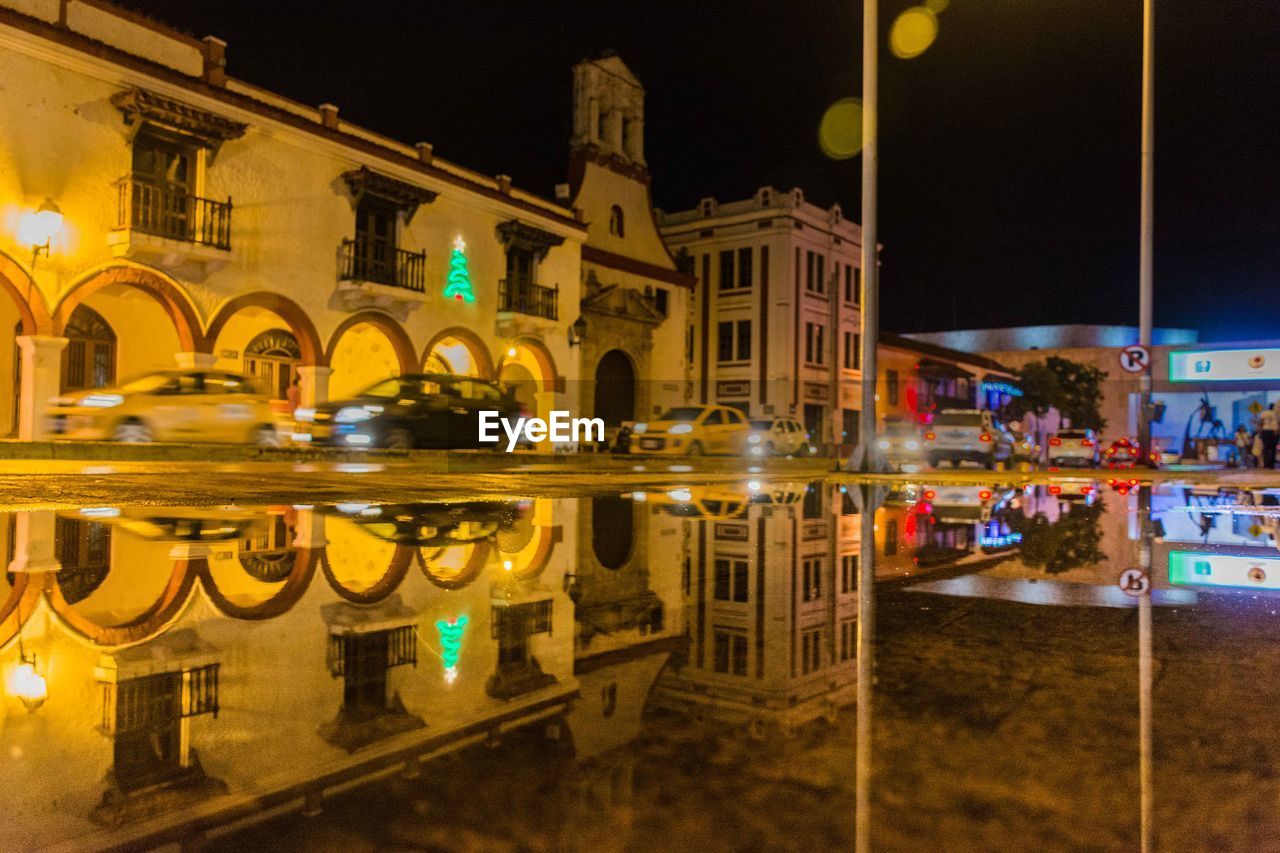 REFLECTION OF ILLUMINATED BUILDINGS IN WATER