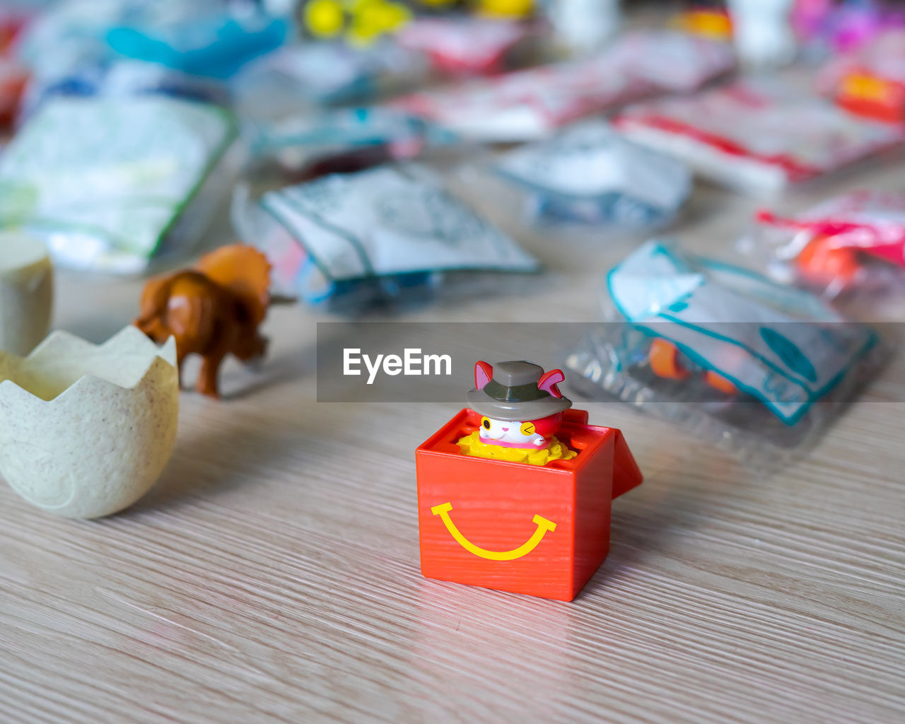 CLOSE-UP OF ORANGE TOY ON TABLE