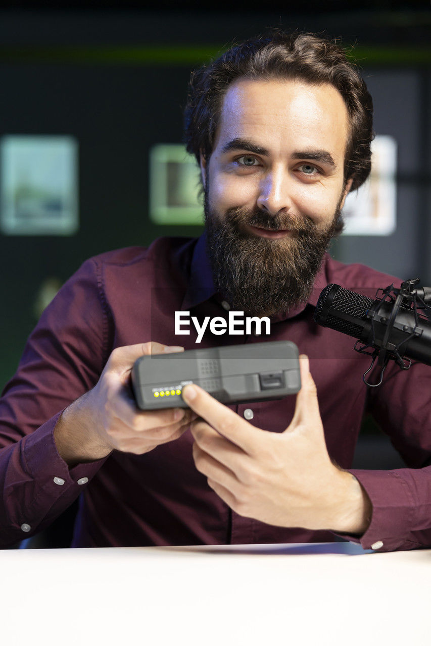 close-up of man using mobile phone at home