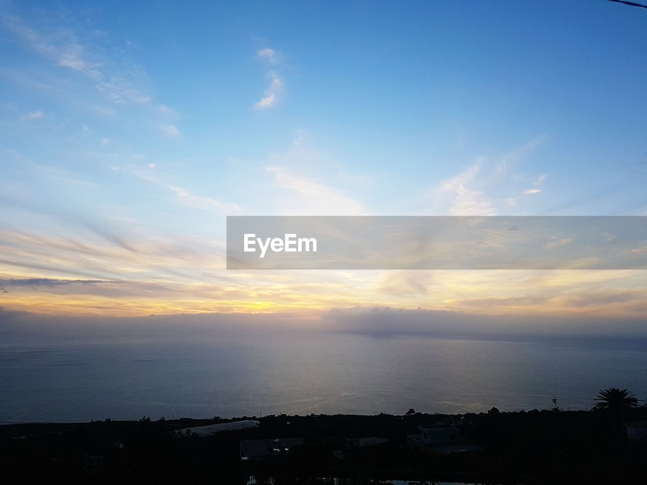 SCENIC VIEW OF SKY OVER SILHOUETTE LANDSCAPE AGAINST SUNSET