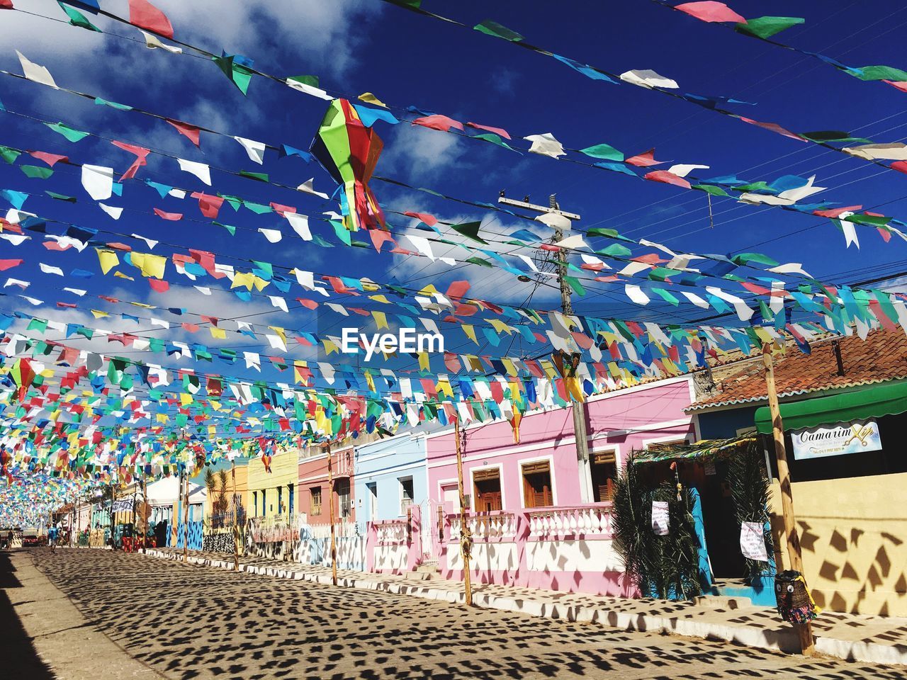 Multi colored flags hanging against sky