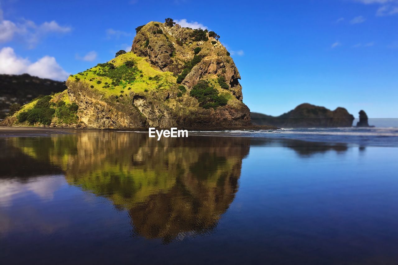 Scenic view of lake and rocks against sky