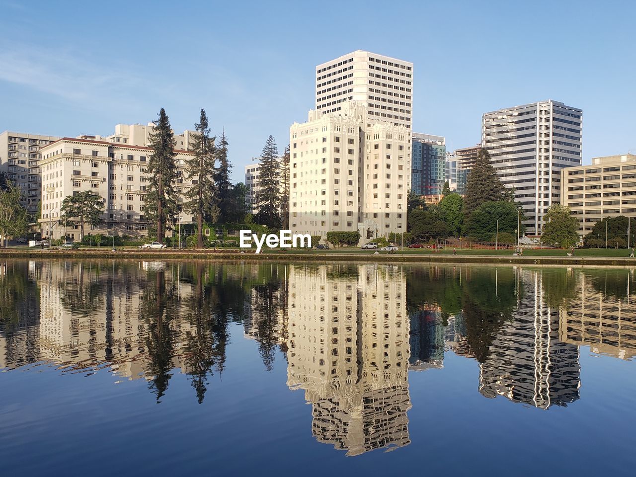 Reflection of buildings in lake against sky