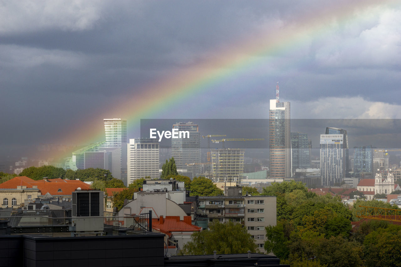 Cityscape against the rainbow in the sky