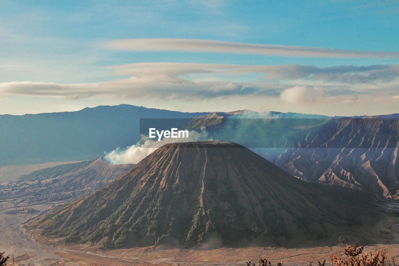 Panoramic view of volcanic landscape against cloudy sky