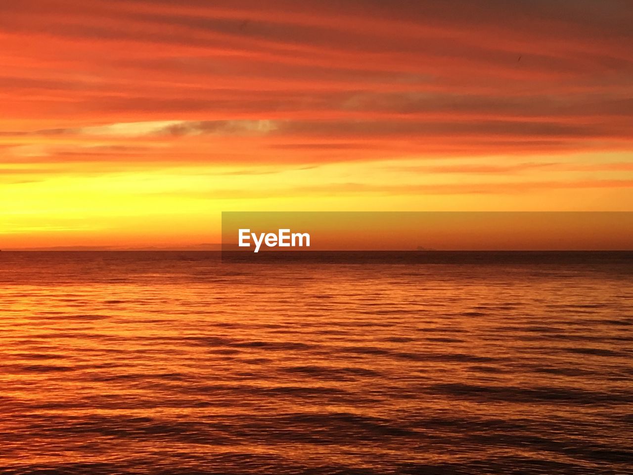 Scenic view of sea against romantic sky during sunset