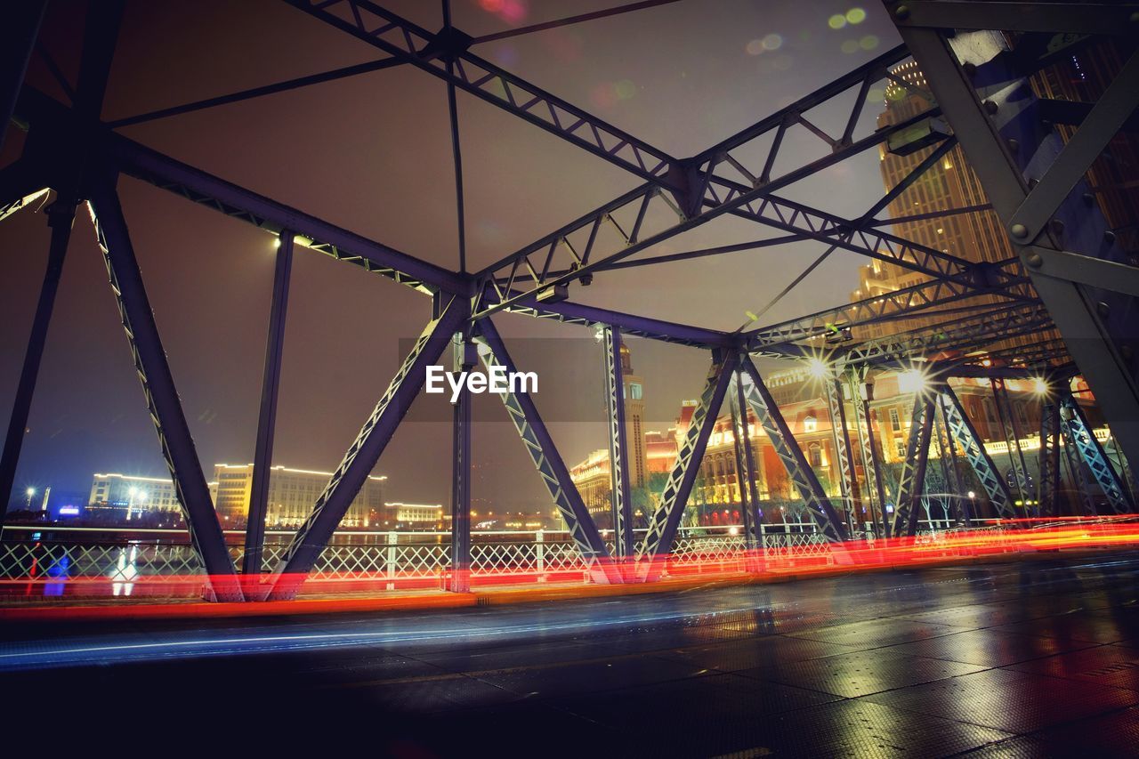 View of illuminated bridge in city at night
