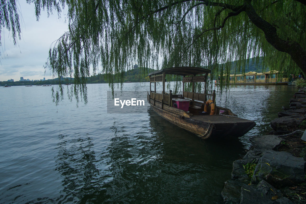 Boat in lake against trees