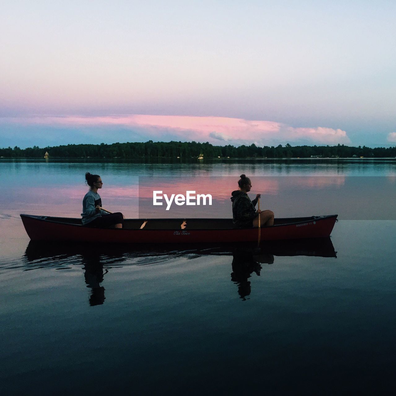 SILHOUETTE OF MAN LOOKING AT LAKE AT SUNSET